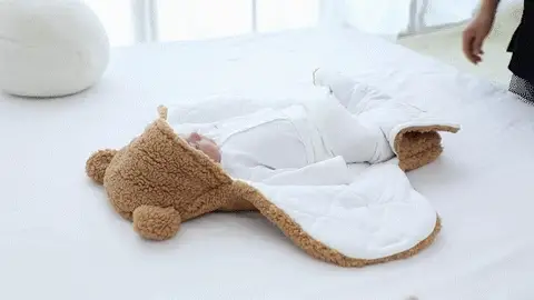 Baby wrapped in a soft swaddle blanket