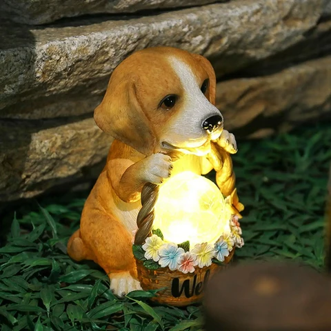 Resin dog figure lit by a solar LED, a weatherproof ornament for the garden