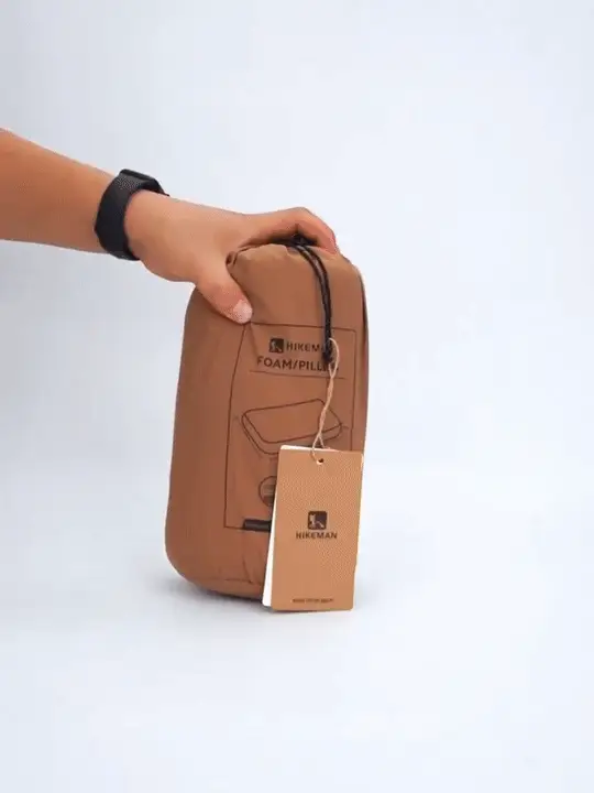 Memory foam camping pillow shown in outdoor use