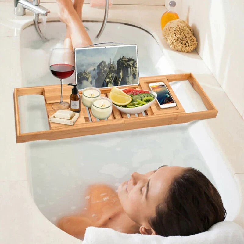 Extendable bamboo bath tray resting across a bathtub