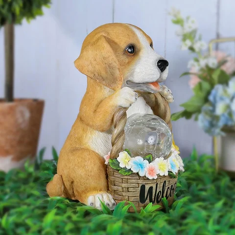 Resin dog figure lit by a solar LED, a weatherproof ornament for the garden