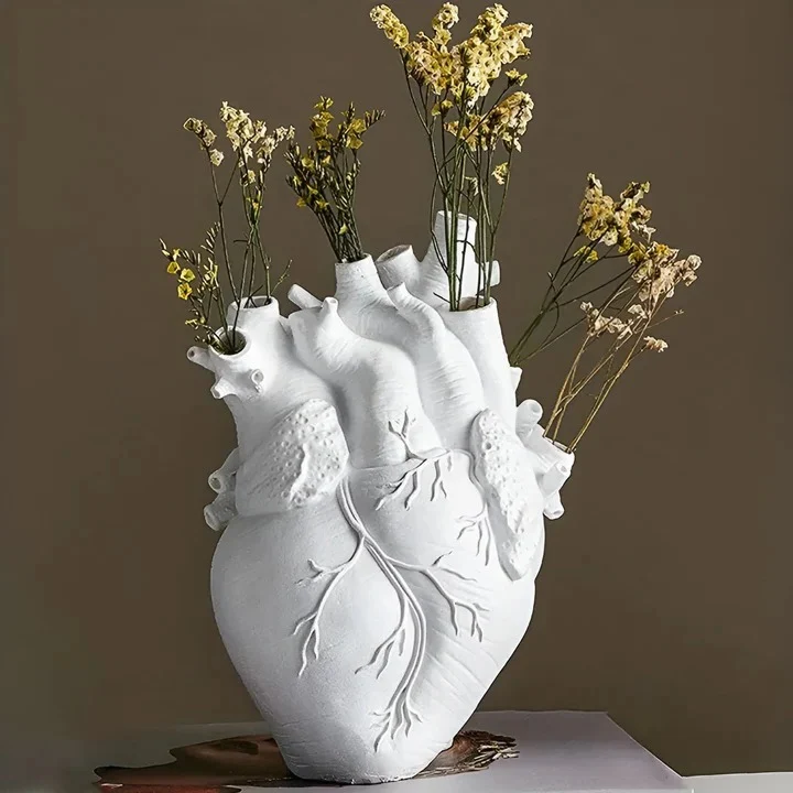 Heart shaped bamboo and wood vase holding flowers