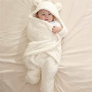 Baby fully wrapped in the closed blanket